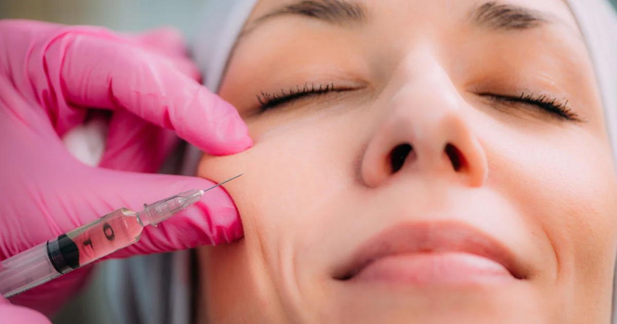 Provider performing a consultation and skin analysis for non-surgical facial rejuvenation in Newport Beach, CA.